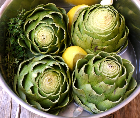 Steamed Artichokes with Garlic Orange Basil Cream Dipping Sauce steaming