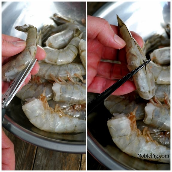 Deveining shrimp into a bowl.