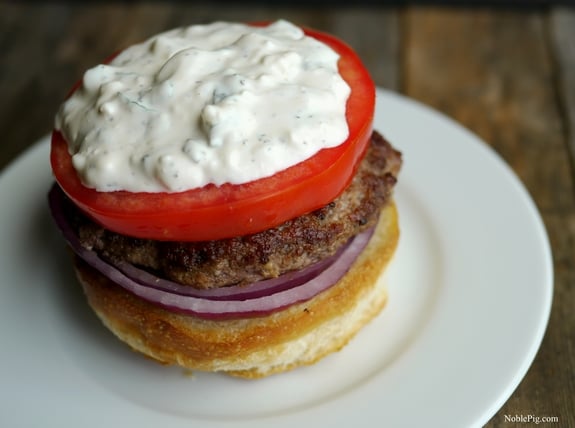 The Juciest Mediterranean Style Burgers with Creamy Feta Curry Dressing open face.