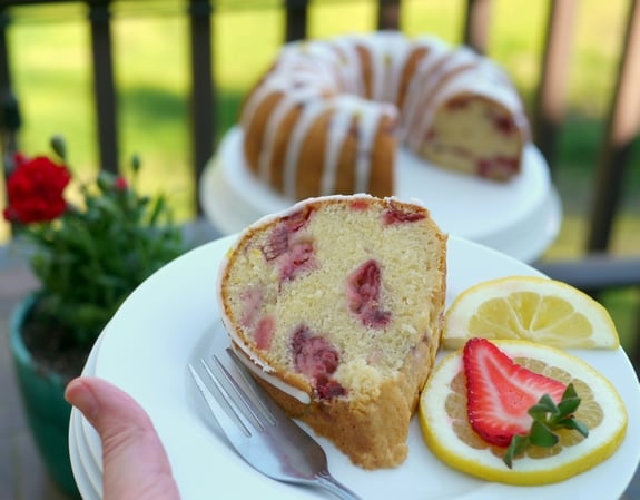 VIDEO + RECIPE: This from scratch Strawberry Lemon Cream Cheese Pound Cake is a deliciously rich cake that is not overly sweet. I've incorporated cream cheese, which is unusual for pound cake. The cream cheese gives the cake a springy crumb texture, richness and tenderness, while keeping the cake moist for several days. It is the perfect choice for strawberry season and beyond from NoblePig.com. #noblepig #poundcake #strawberrycake #cake #lemoncake