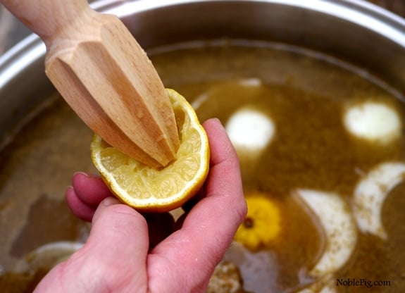 Using a lemon reemer to extrat lemon juice from a lemon.