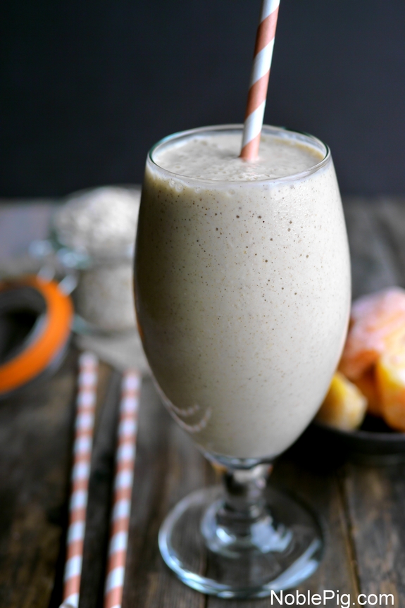 Peach Cinnamon Oatmeal Smoothie in a tall glass with a straw.