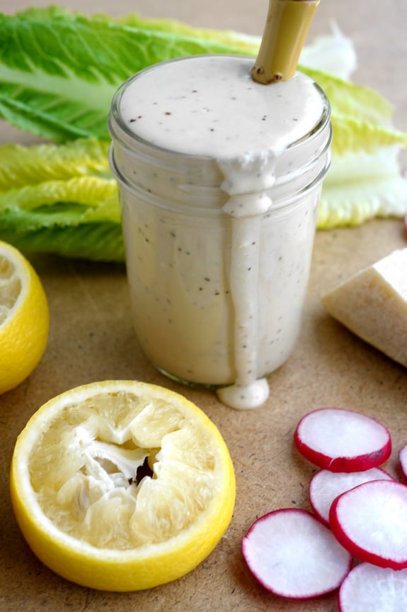 Creamy Parmesan Salad Dressing in a jar with a spoon.