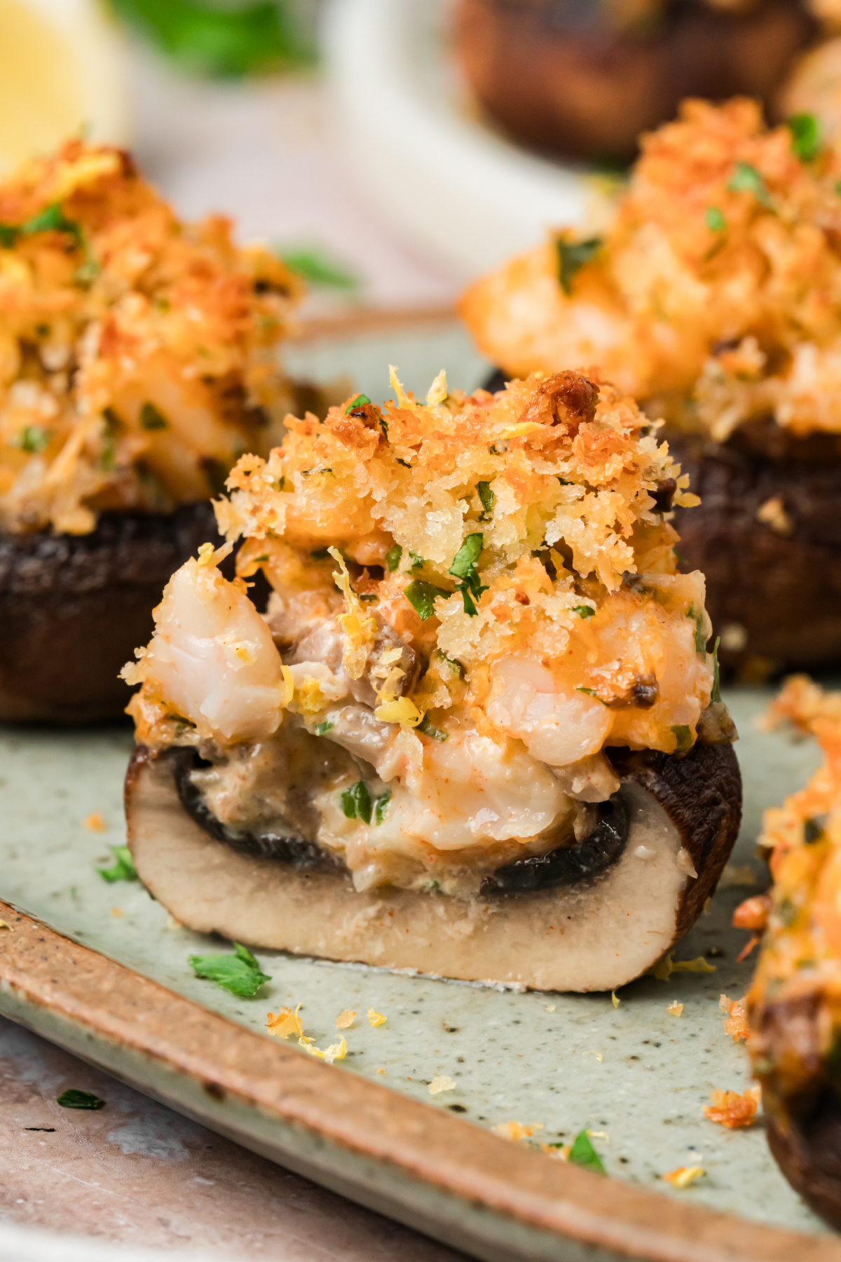Mushroom Stuffed with Shrimp and Cream Cheese Mushroom stuffed with shrimp and cream cheese showing the chopped shrimp and Parmesan panko topping