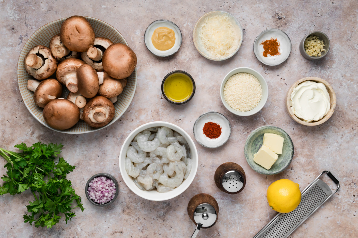 Ingredients for Shrimp Stuffed Mushrooms Ingredients for shrimp stuffed mushrooms including cremini mushrooms, raw shrimp, cream cheese, Parmesan, panko and lemon