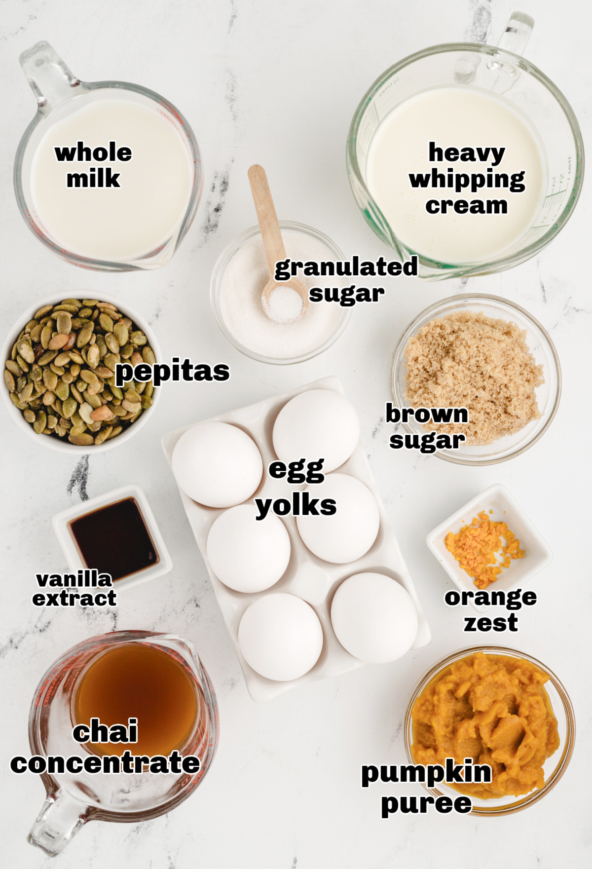 Ingredients for Pumpkin Chai Pots de Cr&egrave;me including pumpkin pur&eacute;e, chai concentrate, egg yolks, cream, brown sugar, and pepitas for brittle.