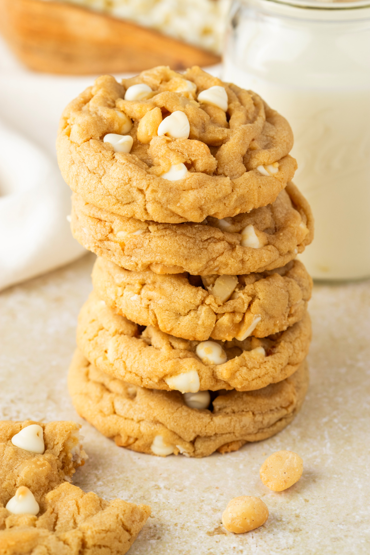 white chocolate macadamia nut cookies stacked thick and soft with white chocolate chips and macadamia nuts