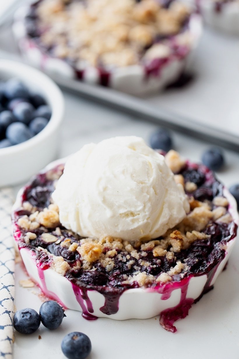 Blueberry crisp with ice cream on top.
