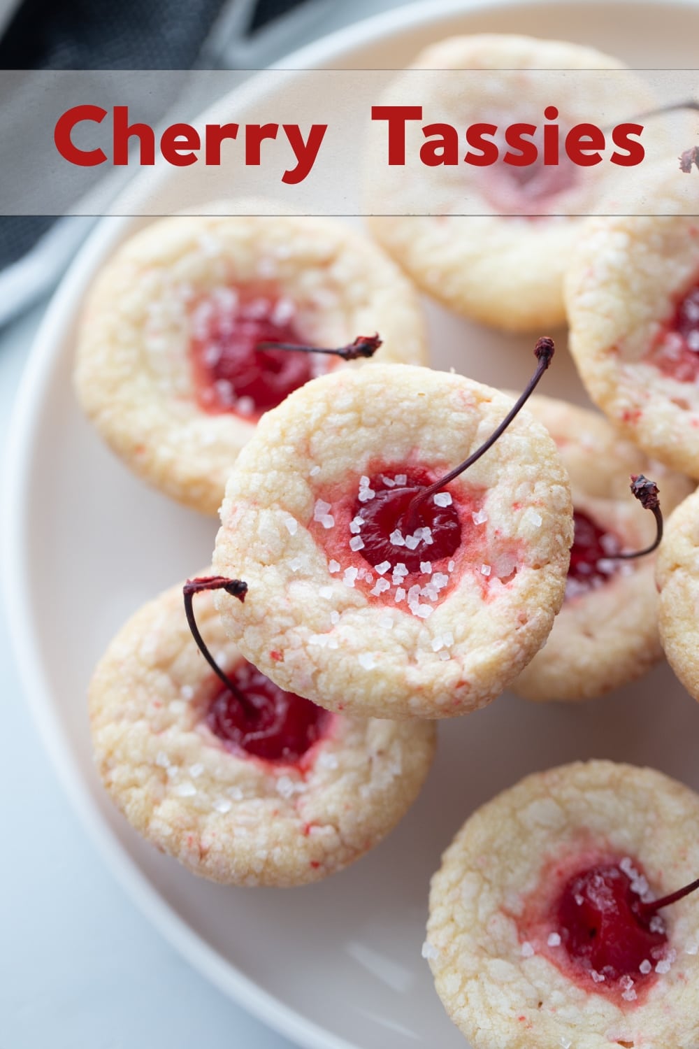 Long stemmed maraschino cherries burst right out the top of these pillowy-soft and bite-sized pastry pouch cookies. They are the perfect addition to any dessert table. via @cmpollak1