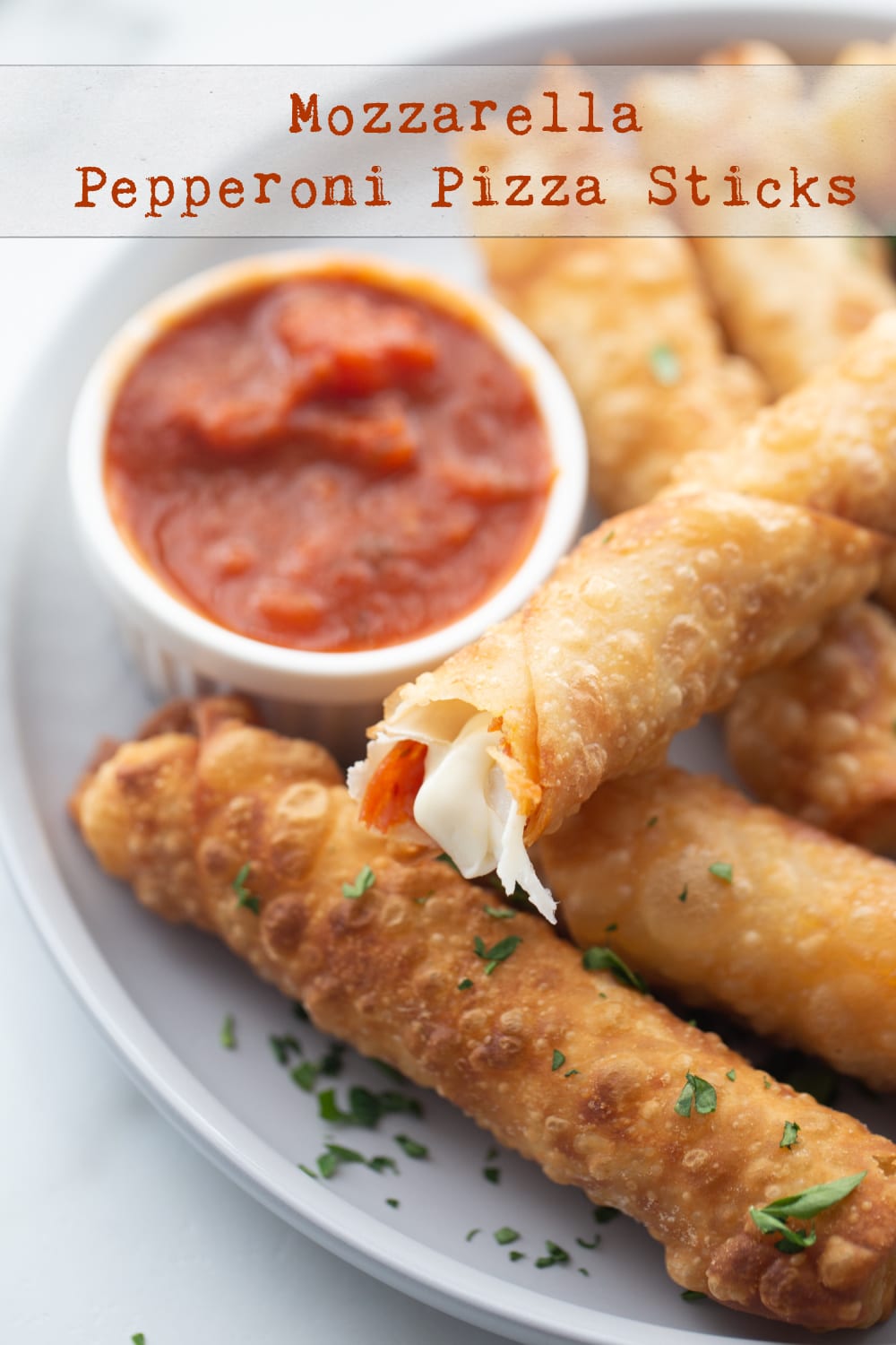 Mozzarella Pepperoni Pizza Sticks made with egg roll wrappers are crunchy on the outside with gooey cheese and pepperoni on the inside. These are a fun appetizer for any party. via @cmpollak1
