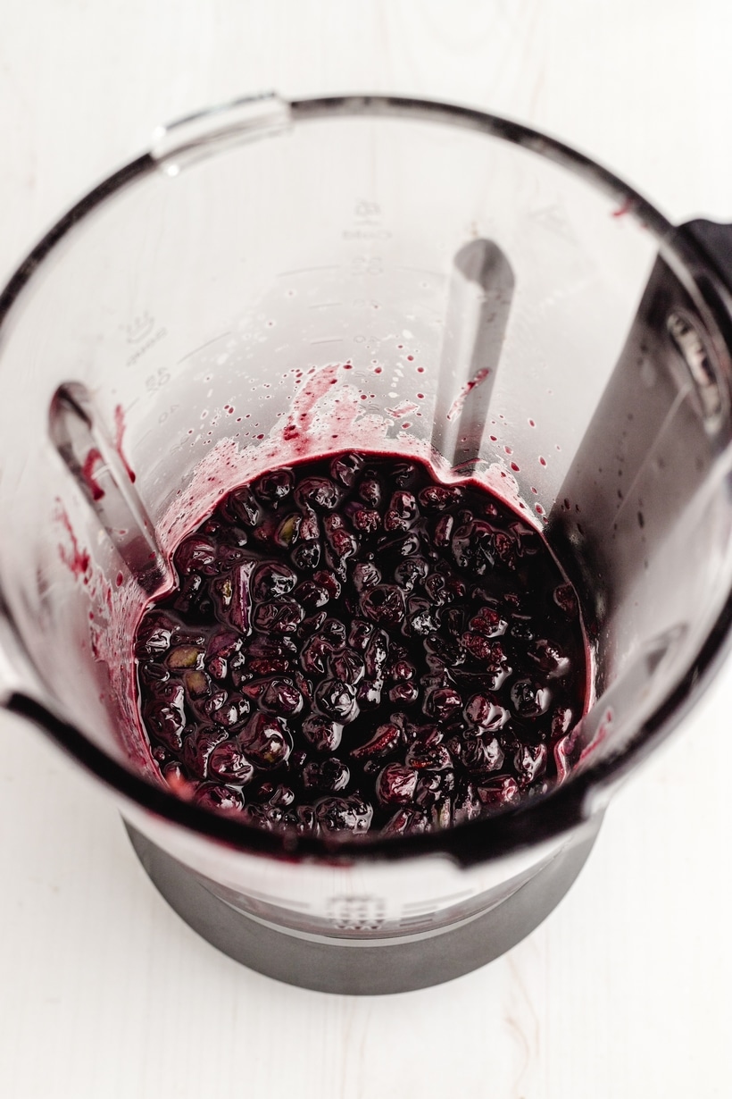 Blender bowl filled with blueberry mixture.