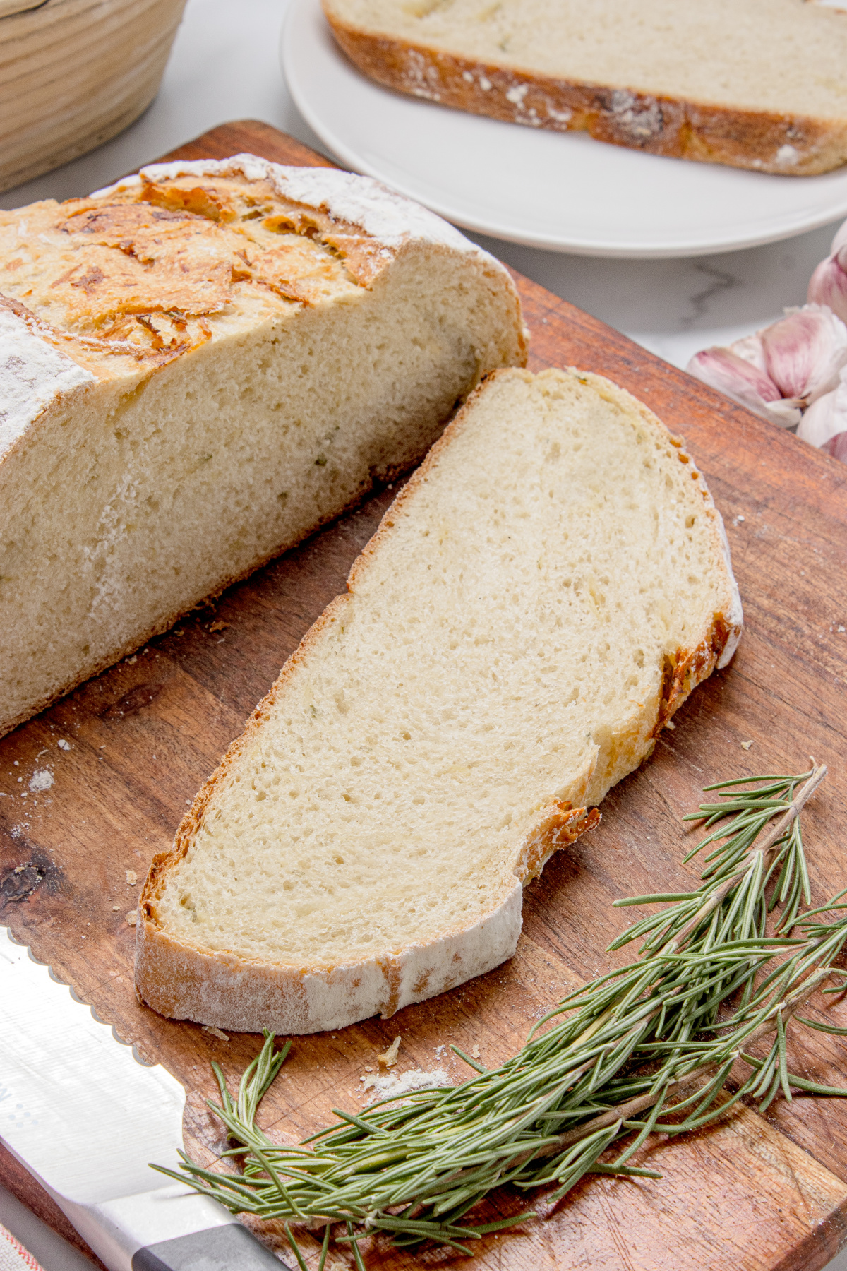 Chewy artisan bread slice with roasted garlic Slice of chewy artisan bread with roasted garlic and rosemary baked into the loaf