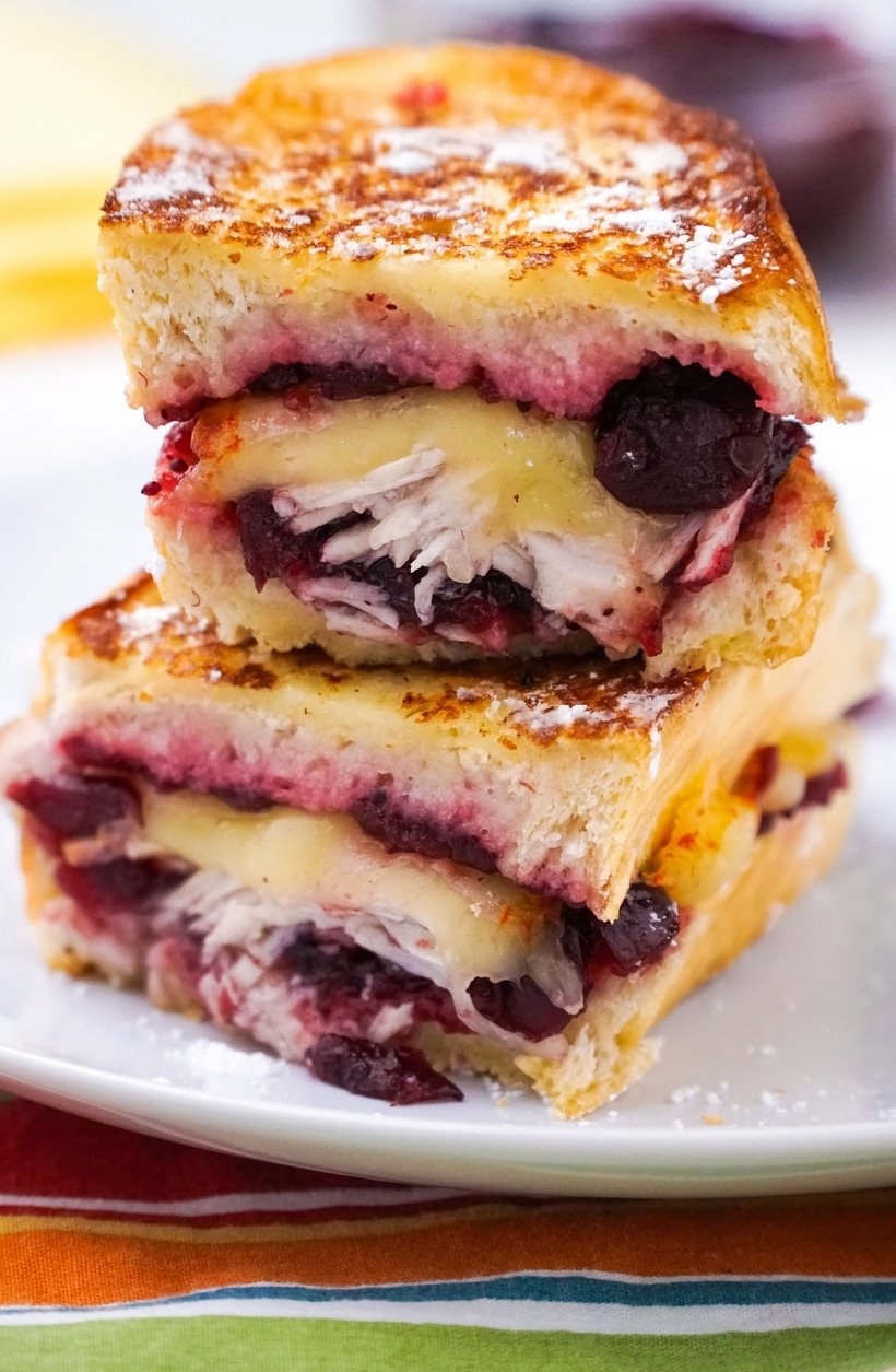 Leftover turkey becomes next-level deliciousness with these Leftover Turkey-Cranberry Monte Cristo Sandwiches. You almost can't wait to get up the next day and make them! #leftoverturkey #noblepig #leftoverturkeyrecipe #montecristo #montecristosandwich #leftovercranberrysauce #cranberry #cranberries #easyleftoverturkeyrecipe #thanksgivingleftovers