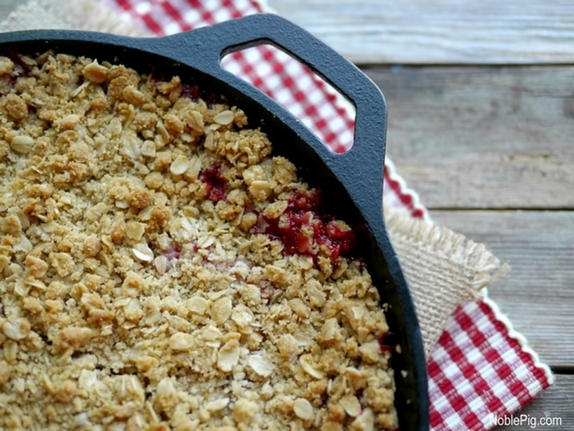 Strawberry-Banana Crumble in a cast iron panwith oat topping.