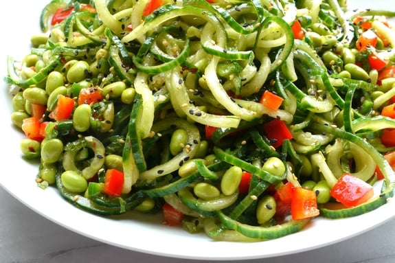 Cucumber Edamame Salad with Ginger-Soy Vinaigrette in a white bowl.
