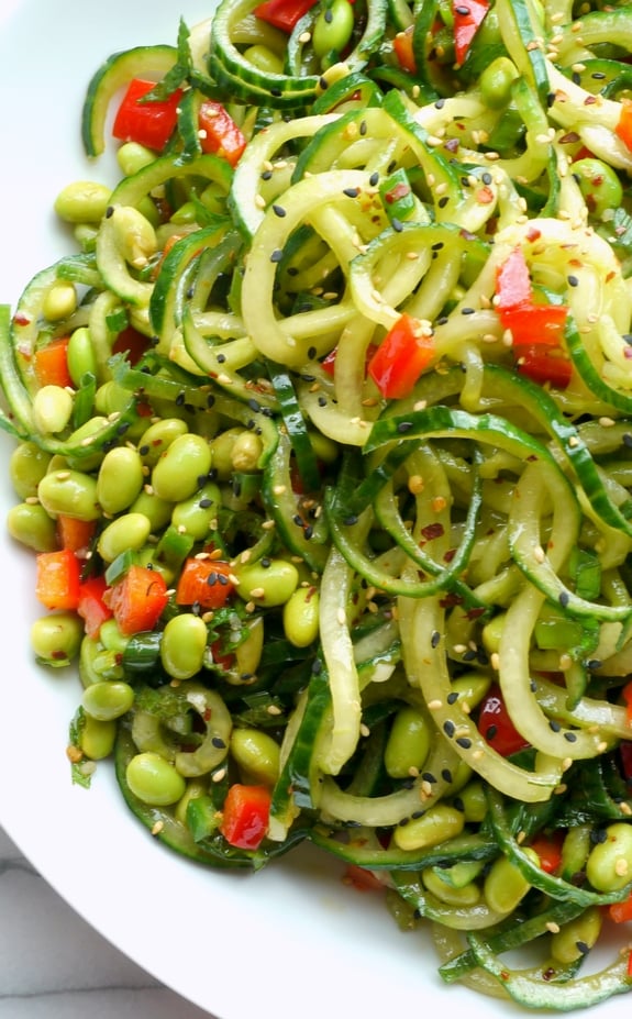 Overhead of Cucumber Edamame Salad with Ginger-Soy Vinaigrette in a white dish.