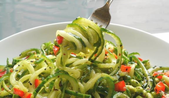 Cucumber Edamame Salad with Ginger-Soy Vinaigrette with a fork lifting some.