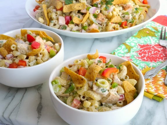 Kicked-Up Chicken-Macaroni Salad in three bowls with a colorful napkin.