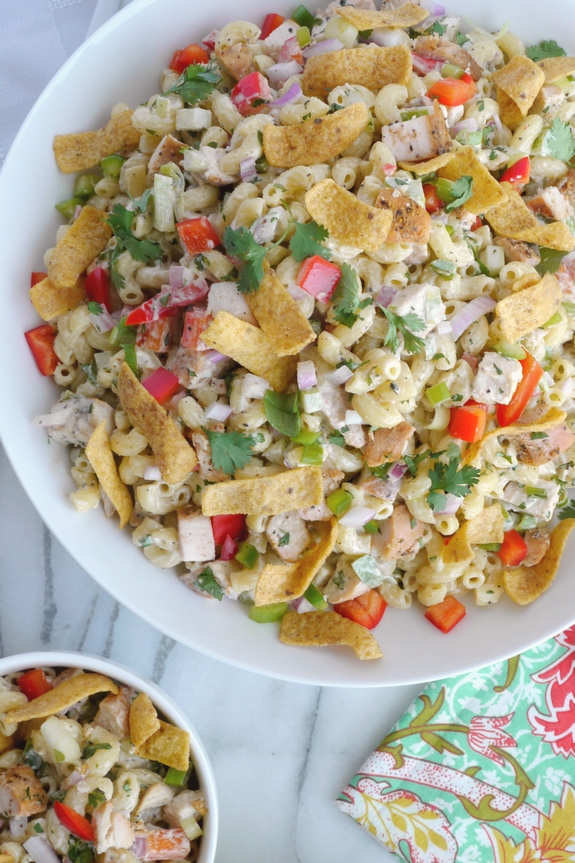 Overhead view of Kicked-Up Chicken-Macaroni Salad in two bowls with a colorful napkin.