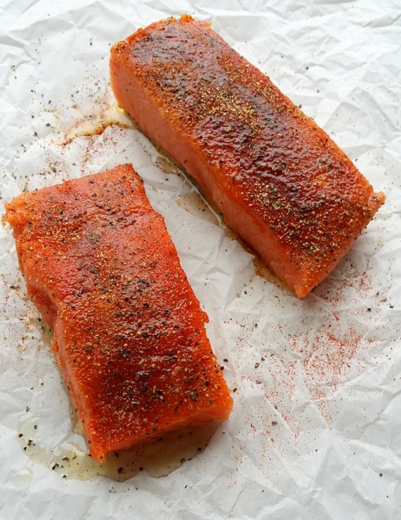 Raw salmon on parchment paper.