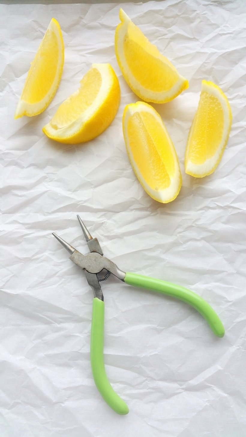 Sliced lemons with a pair of needle-tipped pliers.