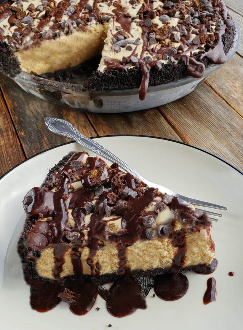 A slice of mud pie with the whole mud pie in the background.