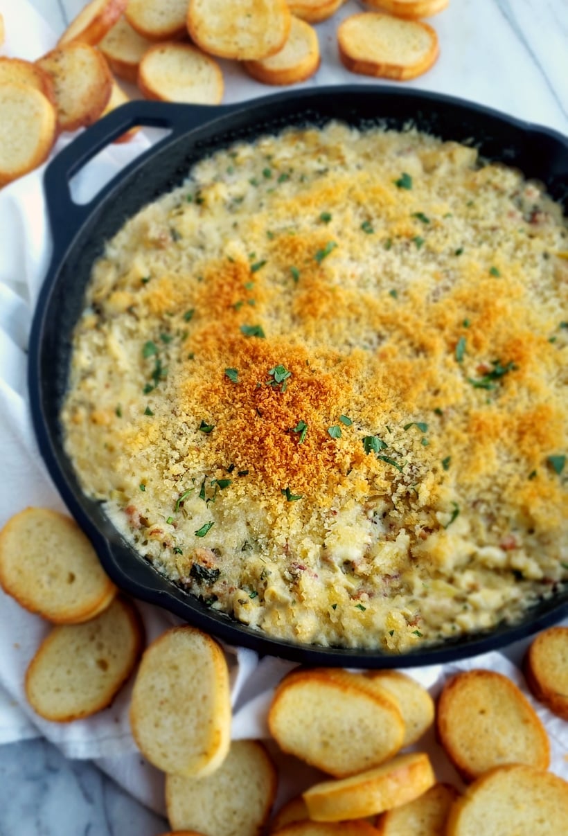Buttery Brie cheese covered with a layer of baked bread crumbs reveals a hot dip packed with crab, artichoke and bacon. It doesn't get much better than this Warm Brie, Crab and Artichoke Dip