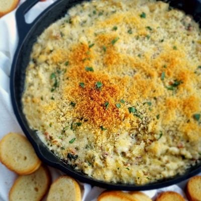 Buttery Brie cheese covered with a layer of baked bread crumbs reveals a hot dip packed with crab, artichoke and bacon. It doesn't get much better than this Warm Brie, Crab and Artichoke Dip!