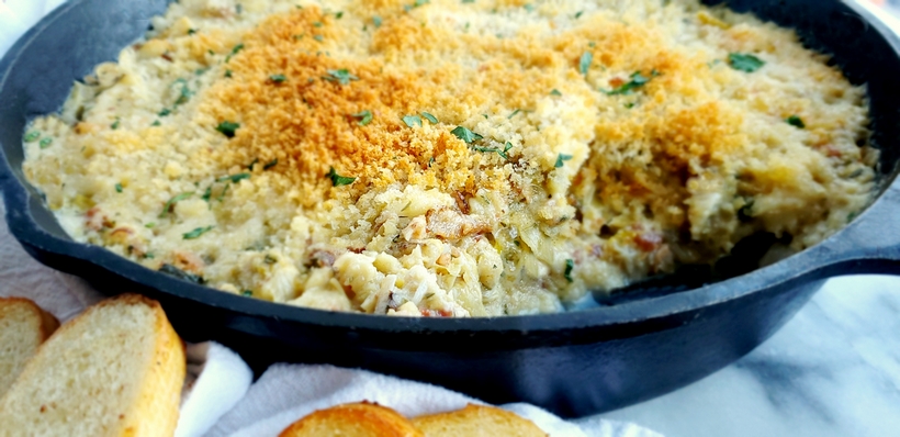 Buttery Brie cheese covered with a layer of baked bread crumbs reveals a hot dip packed with crab, artichoke and bacon. It doesn't get much better than this Warm Brie, Crab and Artichoke Dip! #noblepig #lowcarb #ketorecipe #crabdip