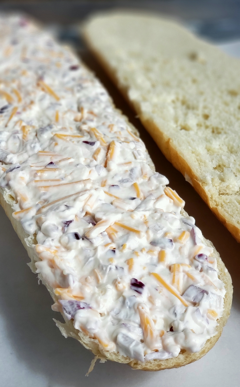 Cheesy Bread Spread will transform your regular loaf of bread into a mouthwatering sensation. Serve this bread with pasta dishes or next to a freshly made salad.Â #cheesybread