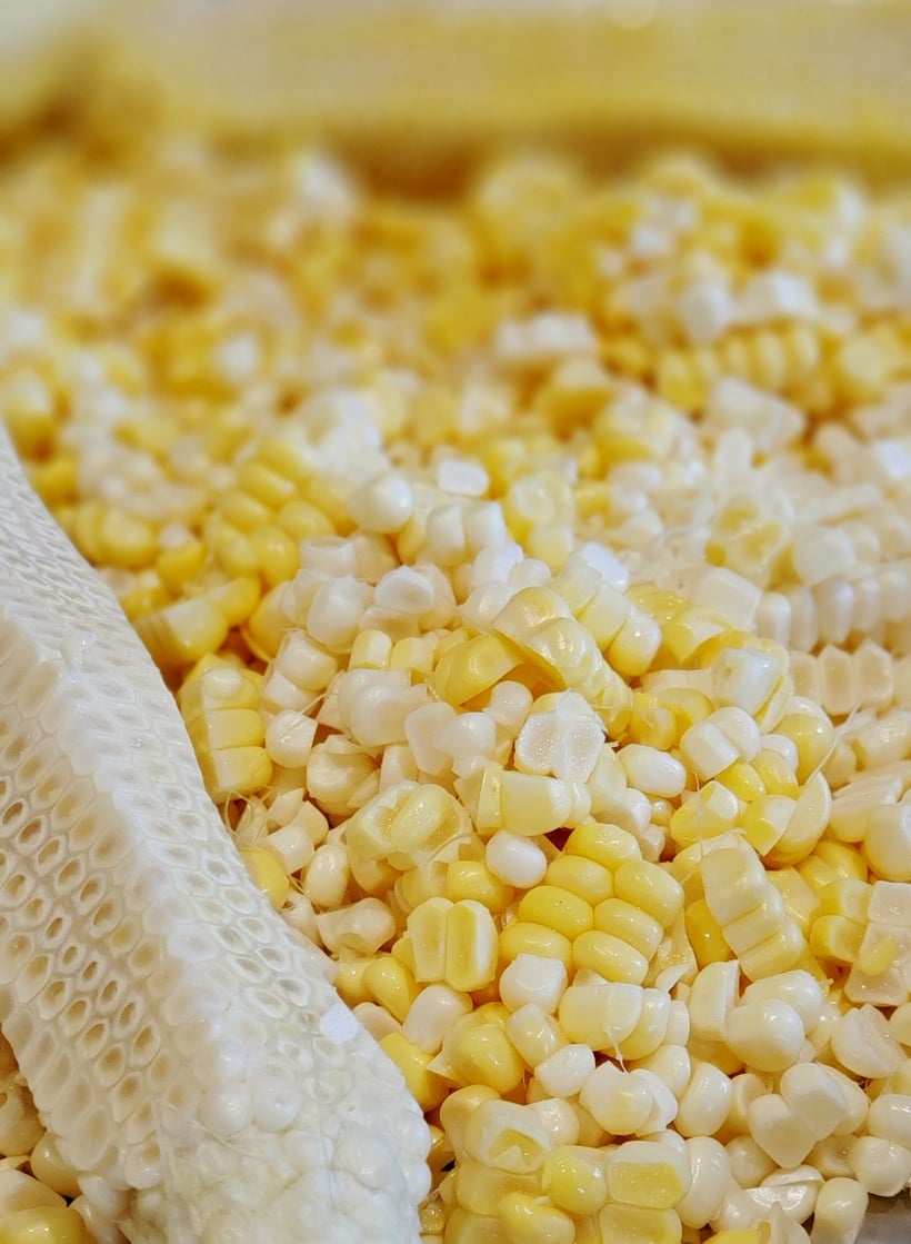 Fresh corn shucked from a cob.