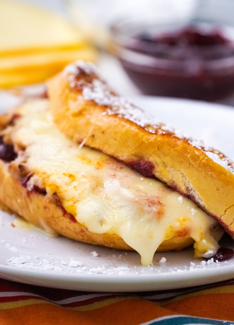 Leftover turkey becomes next-level deliciousness with these Leftover Turkey-Cranberry Monte Cristo Sandwiches. You almost can't wait to get up the next day and make them! #leftoverturkey #noblepig #leftoverturkeyrecipe #montecristo #montecristosandwich #leftovercranberrysauce #cranberry #cranberries #easyleftoverturkeyrecipe #thanksgivingleftovers