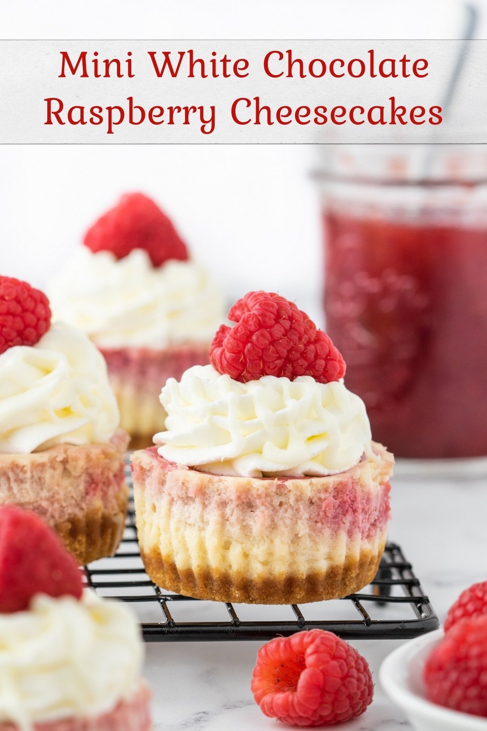 Indulge in these bite-sized treats with a twist! Our Mini White Chocolate Raspberry Cheesecakes are made in a muffin tin, featuring a creamy cheesecake filling with a swirl of tangy raspberries, all nestled on top of a buttery graham cracker crust. Topped generously with a dollop of whipped cream and a drizzle of white chocolate, these cheesecakes are sure to be a hit at your next gathering or just as a sweet treat for yourself. #minicheesecake #raspberry #whitechocolate #dessert #bitesizedtreats #cheesecakerecipes via @cmpollak1
