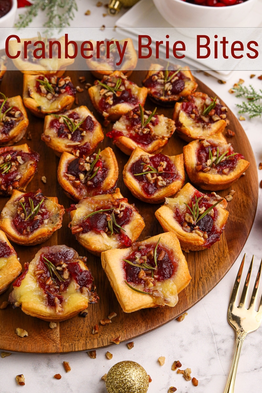 Indulge in the ultimate crowd-pleaser—miniature baked Brie enveloped in buttery crescent dough. Each bite unveils a perfect blend of gooey cheese, sweet-tart cranberry sauce, toasted pecans, and a touch of rosemary for a memorable appetizer bite. These cranberry Brie bites are perfect for the holiday season. via @cmpollak1