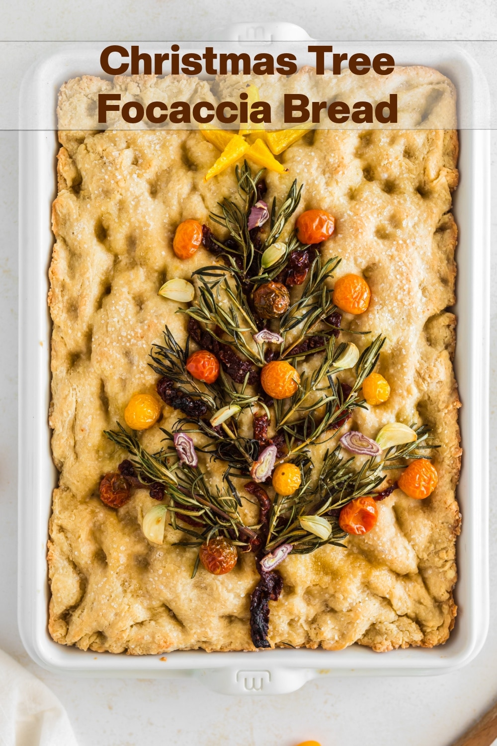 Transform your holiday spread into an edible centerpiece with this Christmas Tree Focaccia Bread - where a savory canvas of golden dough meets a merry medley  of festive "evergreen" made from rosemary sprigs, tomatoes, shallots and garlic. It's as flavorful as it is eye-catching.  via @cmpollak1