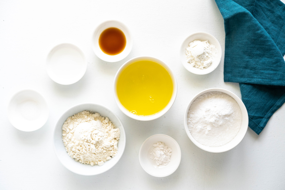 Ingredients for angel food cupcakes including egg whites, superfine sugar, flour, cornstarch, cream of tartar, and vanilla