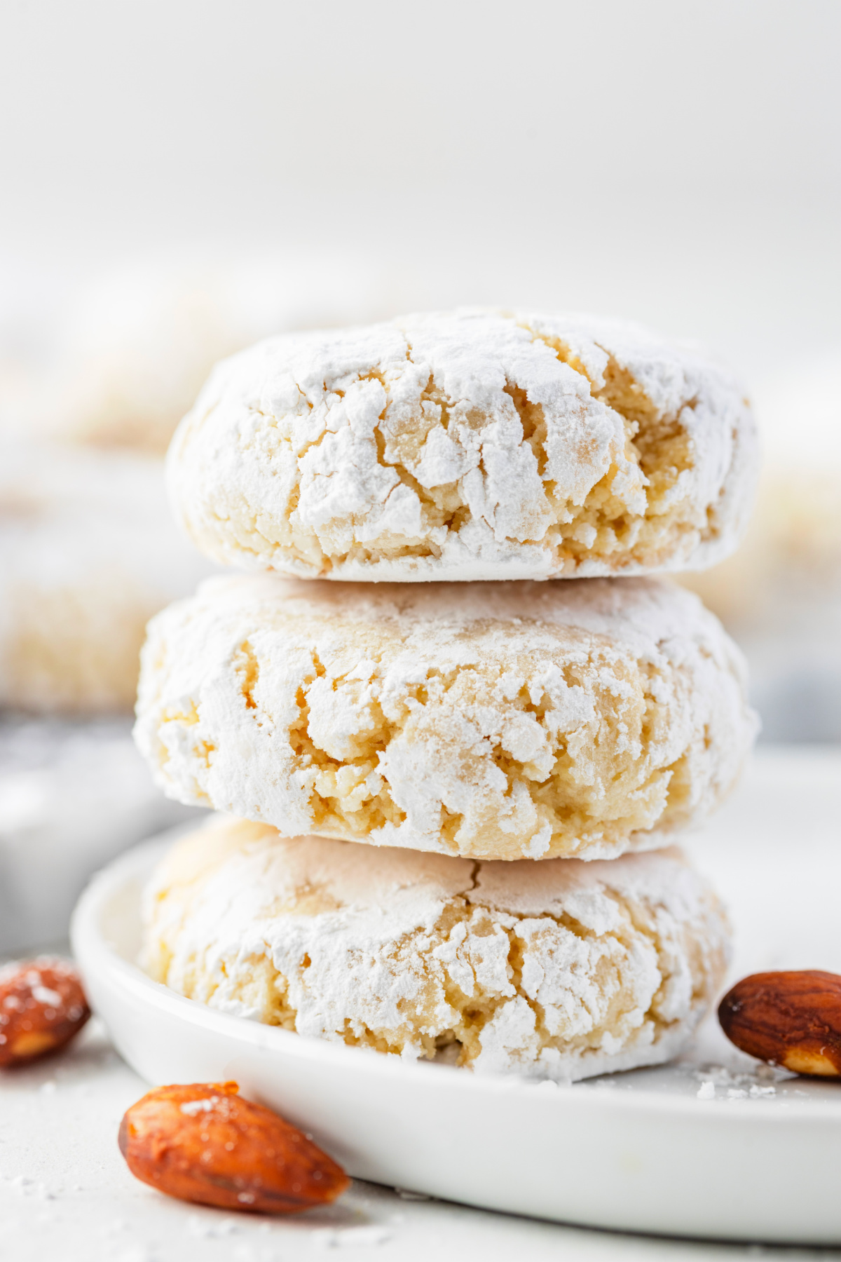 A soft amaretti-style almond cookie broken open to show its tender, chewy center.