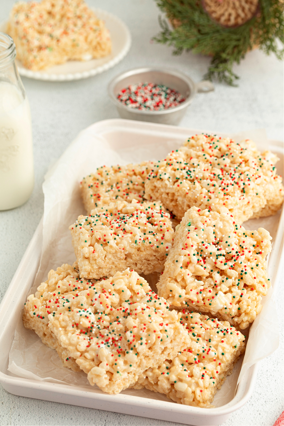 Christmas Sugar Cookie Rice Krispie Treats arranged on a tray with festive sprinkles, ready for sharing.