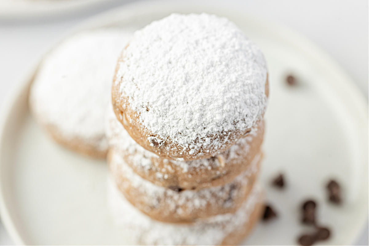 A stack of soft, sugar-dusted cookies showing their tender texture.