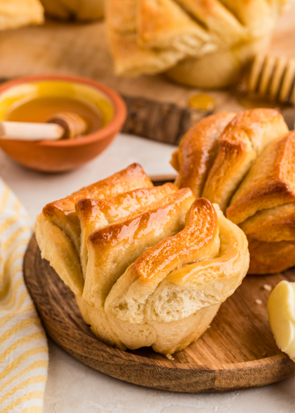 Honey butter pull-apart rolls baked in a muffin tin with soft layered sides and a golden top.