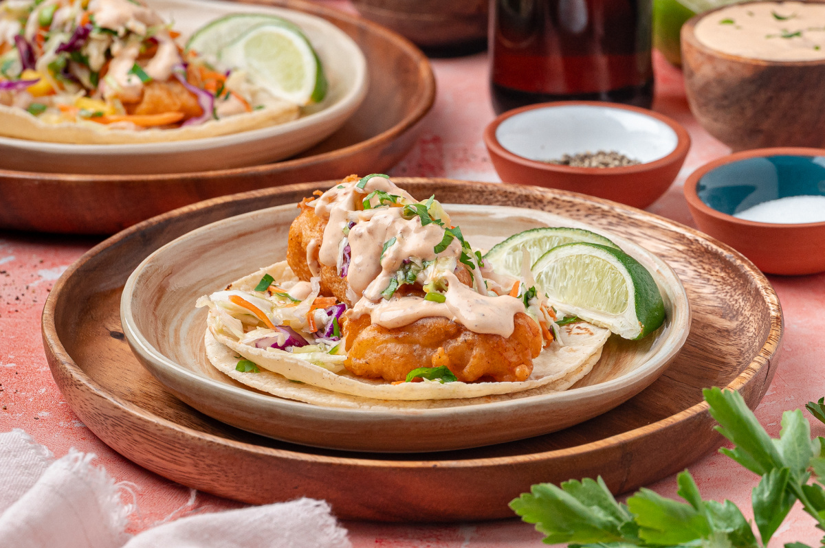 Crispy fried cod tacos topped with mango slaw and chipotle lime sauce on corn tortillas.