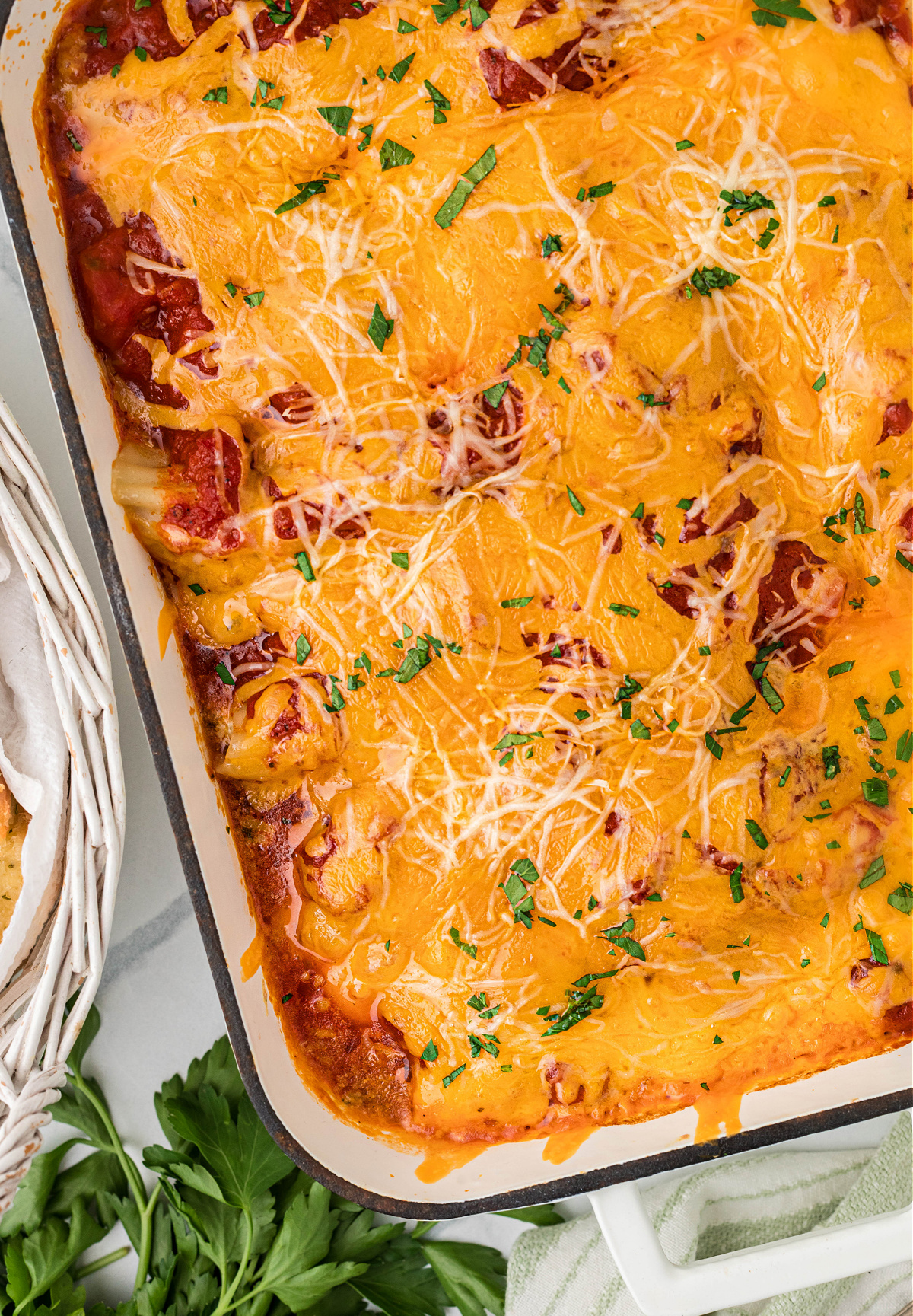 Baked manicotti in a 9&times;13 pan with marinara, ricotta filling, and melted sharp cheddar cheese