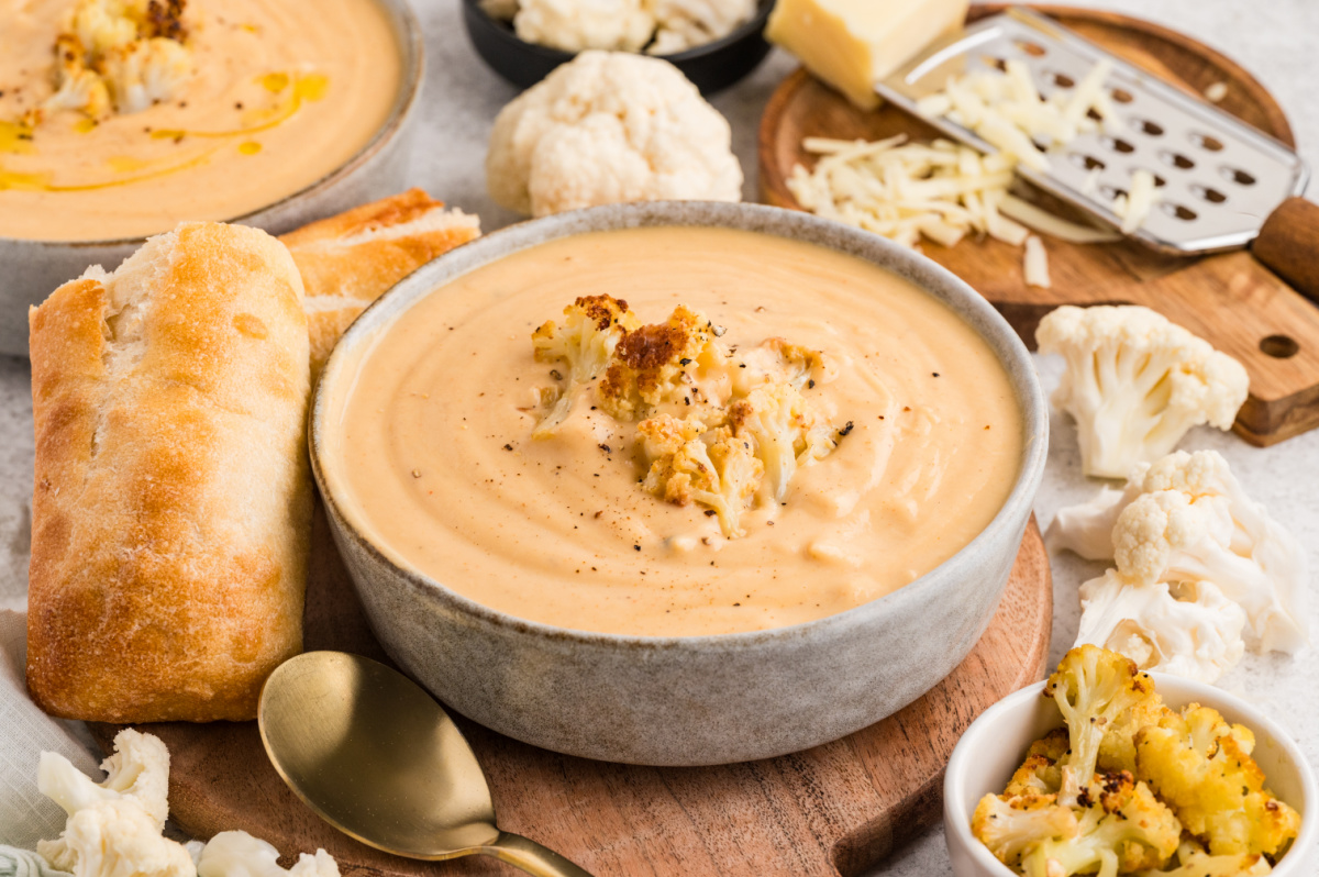 Roasted Cauliflower Soup served in a bowl with crusty bread, garnished with caramelized cauliflower florets.