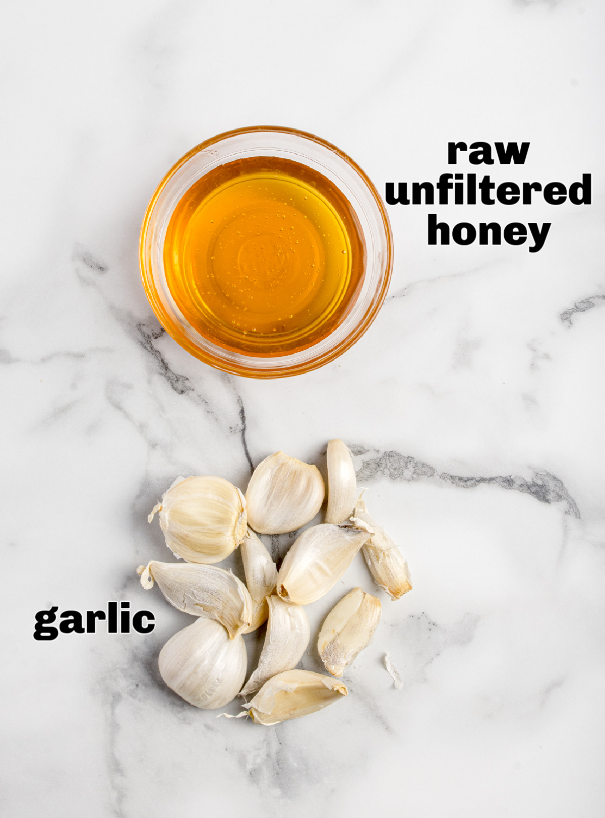 Raw unfiltered honey and whole garlic cloves shown side by side as the two ingredients used for fermentation.