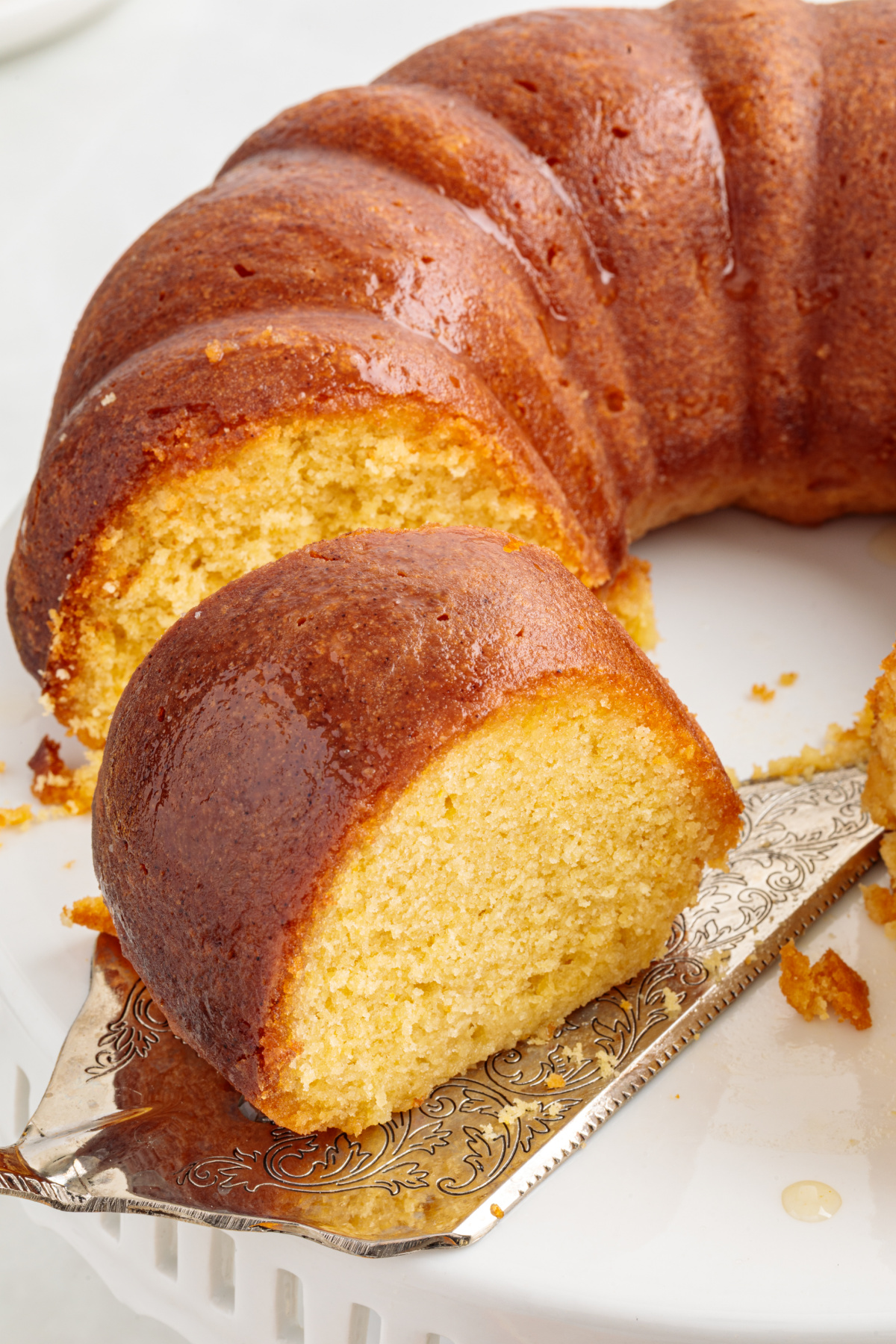 Italian Hangover Cake sliced to show a golden, syrup-soaked crumb in a Bundt cake.