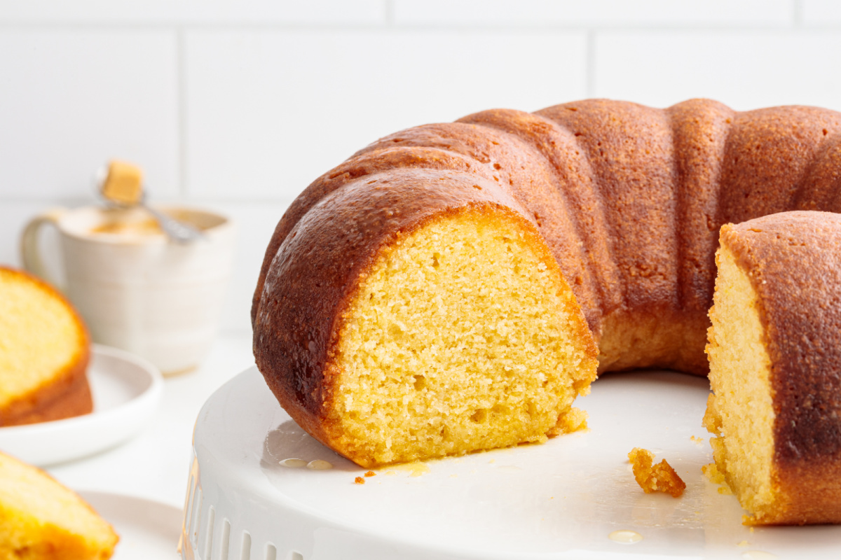 Syrup-soaked olive oil Bundt cake with a golden crumb on a cake stand.