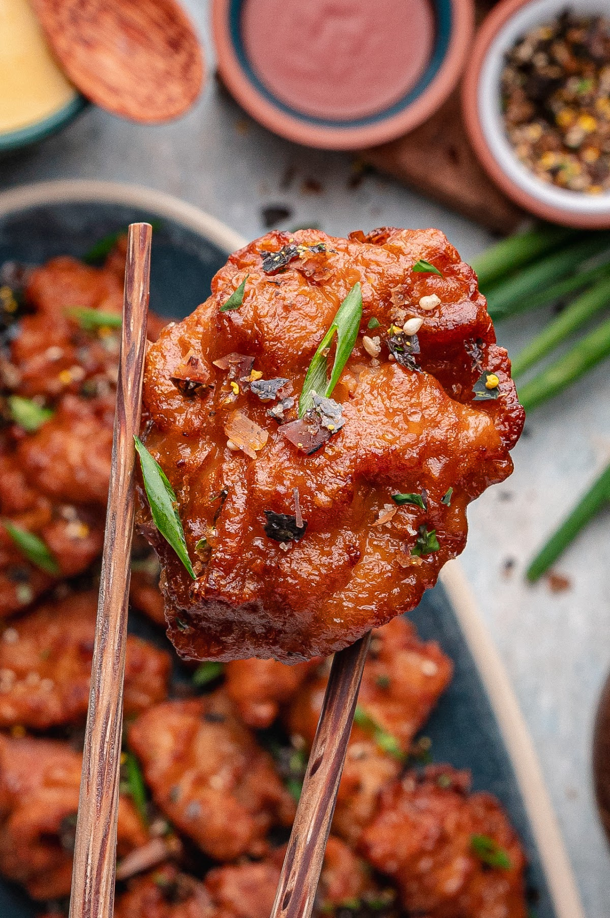 crispy mochiko chicken bite with glossy sauce and furikake