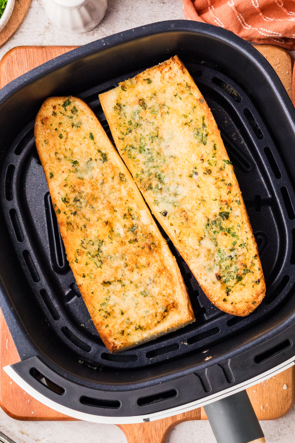 Garlic confit air fryer bread cooking in the air fryer basket until golden and crisp