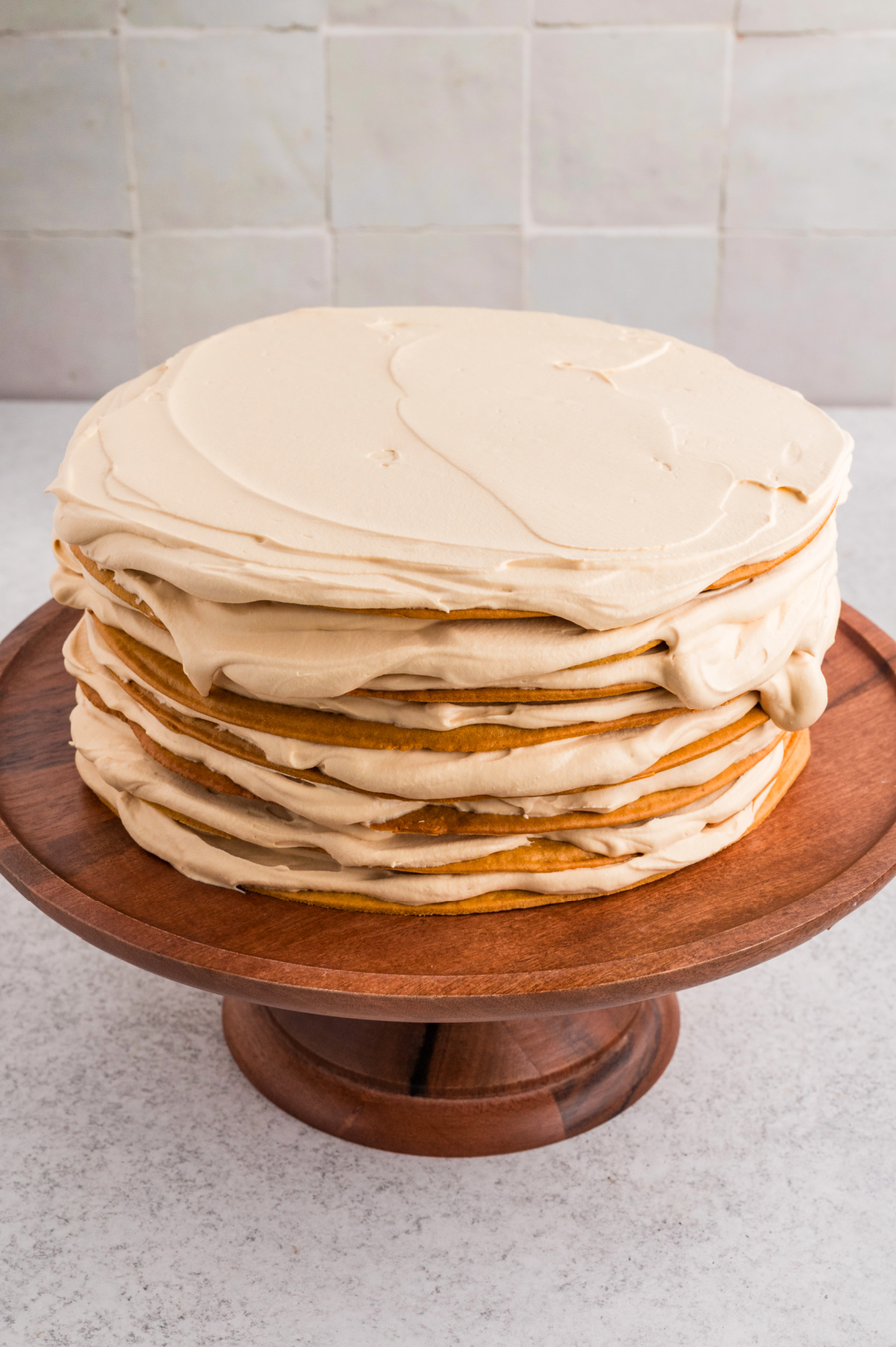 Russian honey cake (Medovik) assembled with thin honey layers and whipped dulce de leche frosting before chilling.