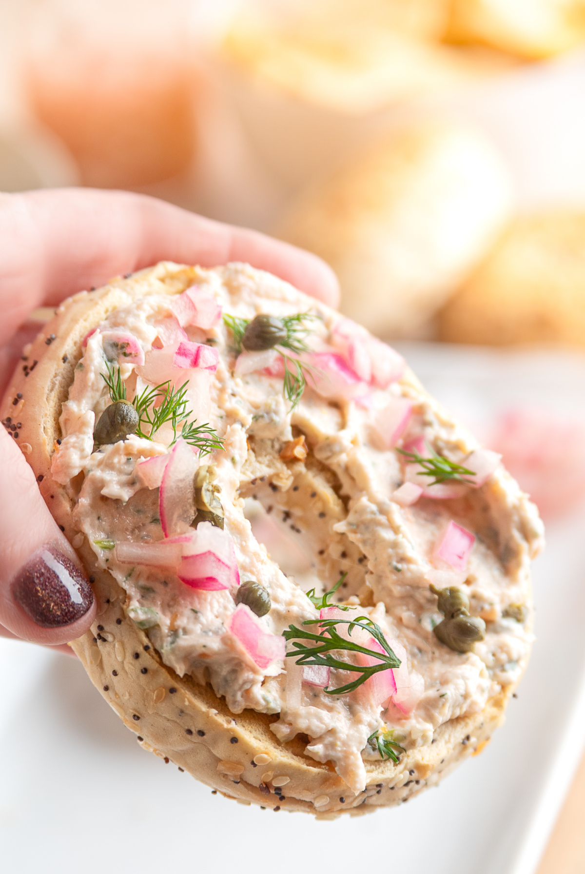 Creamy salmon spread on an everything bagel, topped with capers, pickled red onions, and fresh dill.